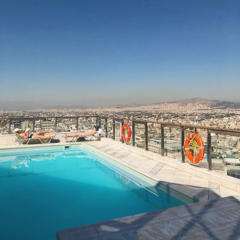 A rooftop pool overlooking the city and hills